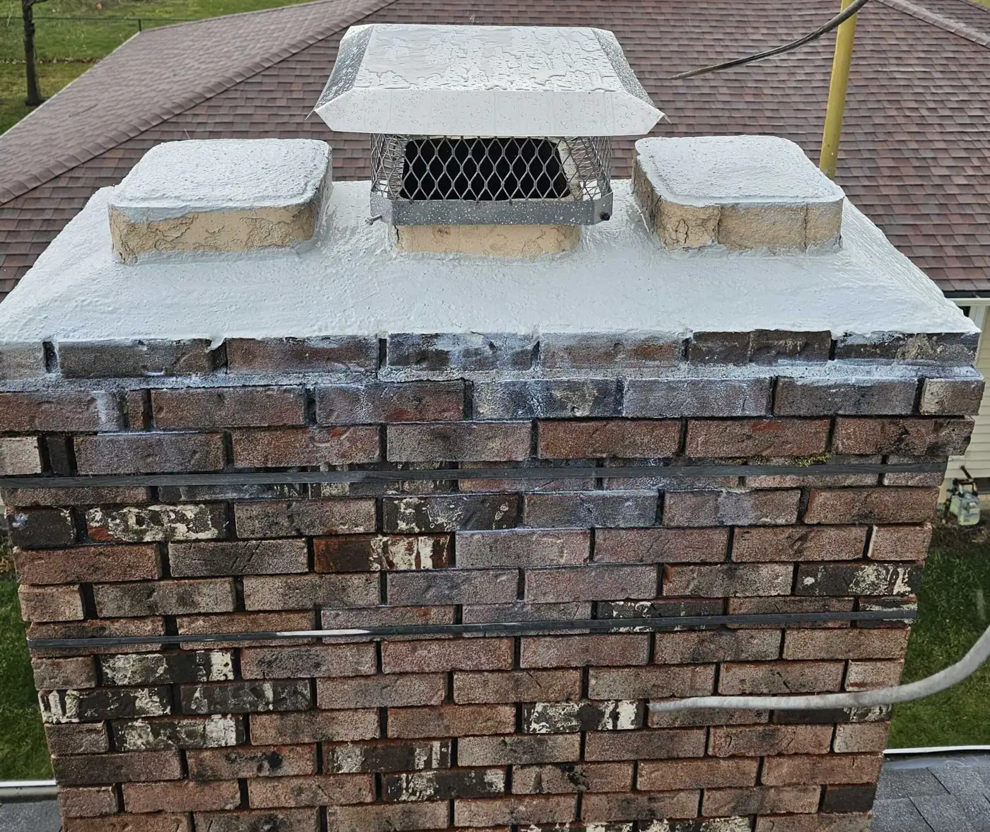 Repaired brick chimney with a new crown by Green and Clean
