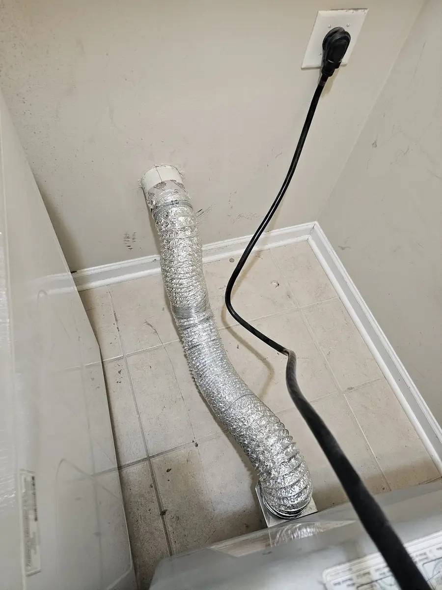 Technician working on ductwork in a Northeast Ohio basement