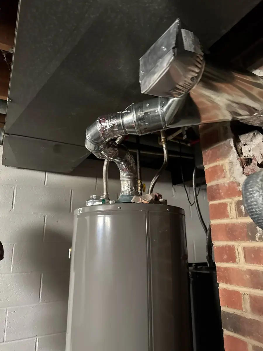 Ladder set against a stone chimney before a liner installation