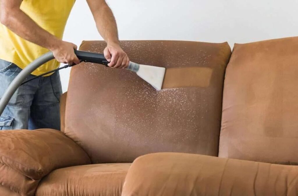 A Green and Clean Home Services technician deep-cleaning a chair, demonstrating the benefits of our upholstery cleaning in Mentor, Ohio.