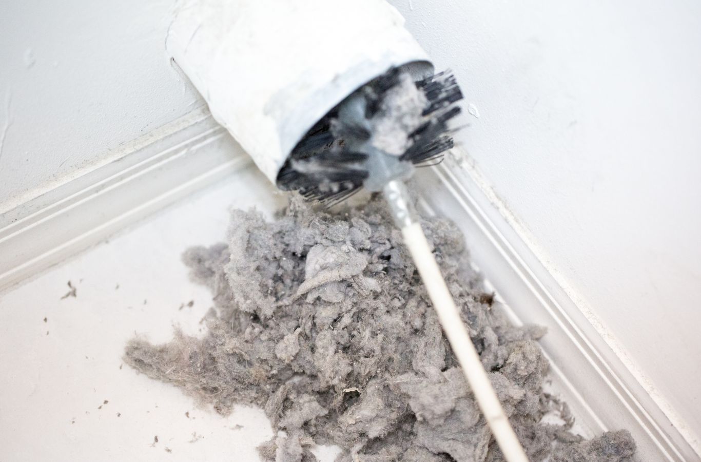 A Green and Clean Home Services technician cleaning dryer vents in a Chardon, Ohio home.