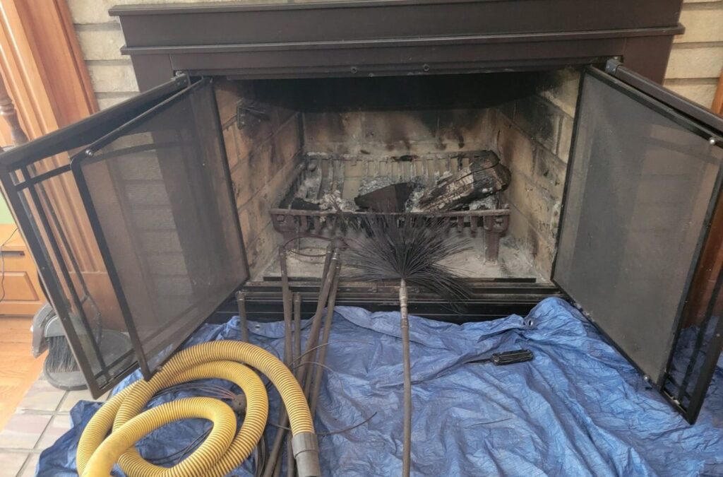 A technician from Green and Clean Home Services cleaning a chimney in Twinsburg, OH, removing dangerous buildup and improving fireplace performance.