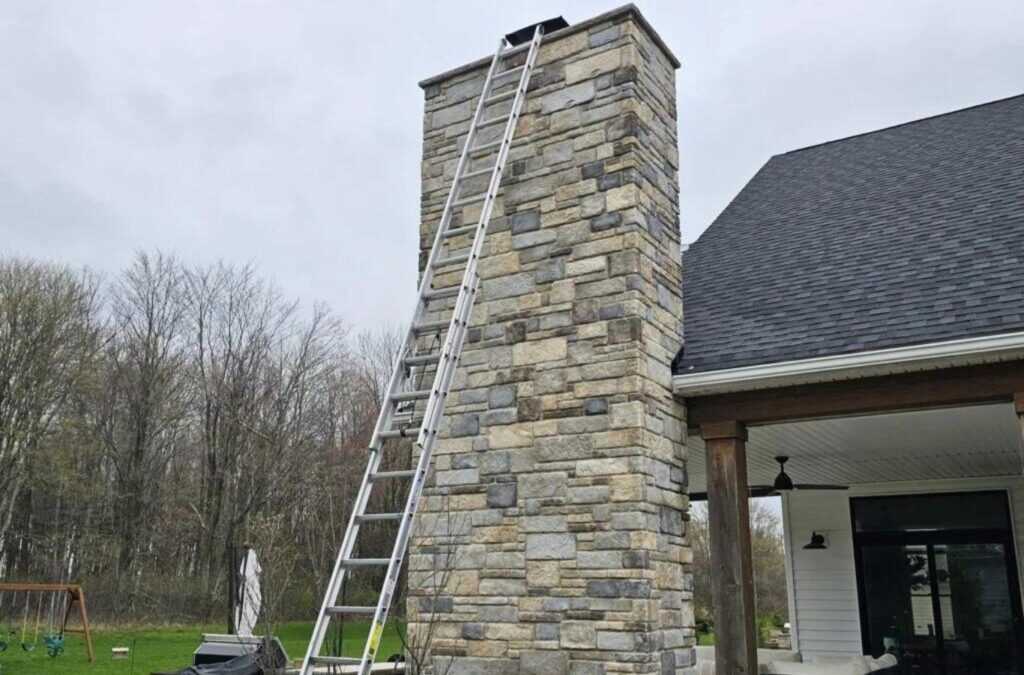 A Green and Clean Home Services technician conducting an inspection in Aurora, OH, highlighting the importance of regular chimney care.