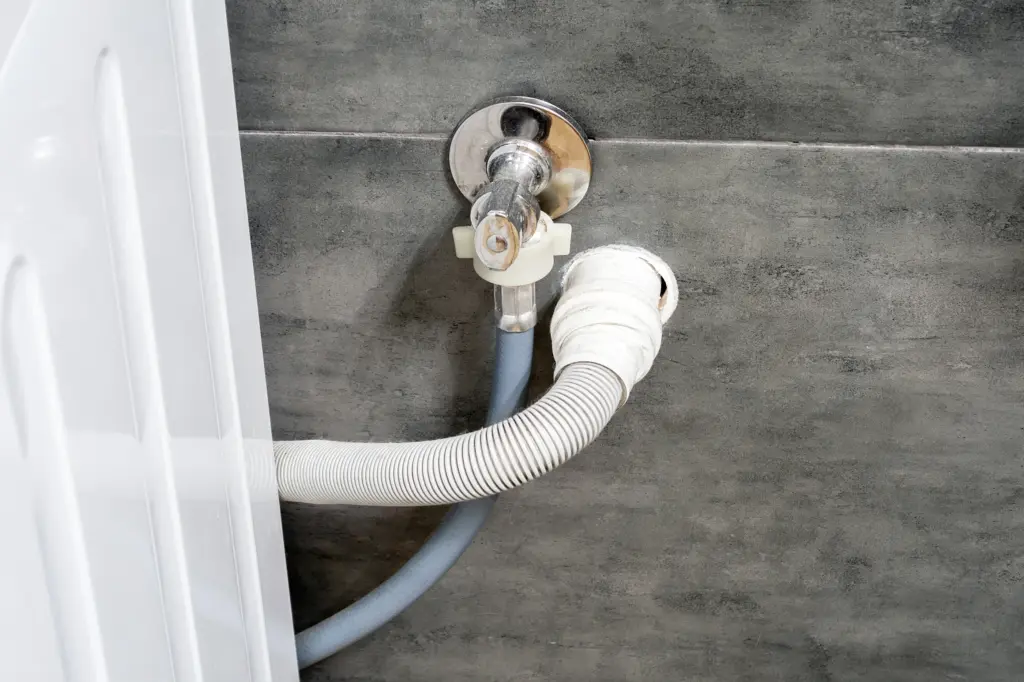 washing machine hose connected to grey wall 2026 03 18 13 44 07 utc jpg